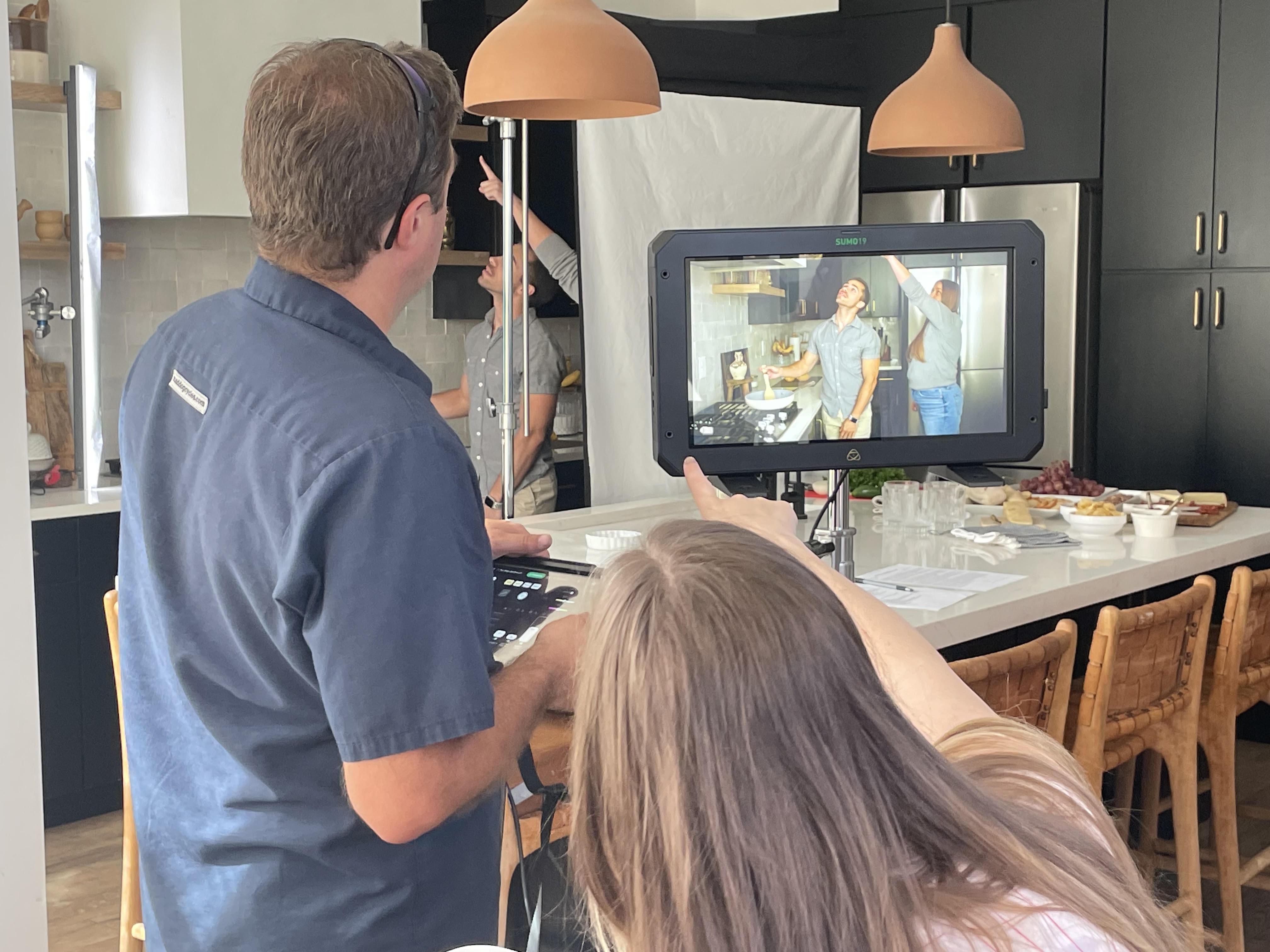 Sarah directing a commercial shoot, calling a frame on the monitor